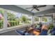 Relaxing porch with comfortable wicker seating, ceiling fans, and charming neighborhood views at 908 N Tremain St, Mount Dora, FL 32757