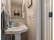 Cozy powder room with a vintage-style sink, neutral paint, and classic fixtures at 908 N Tremain St, Mount Dora, FL 32757