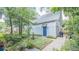 Lovely side yard featuring a brick pathway, a small fountain, and access to the house at 908 N Tremain St, Mount Dora, FL 32757