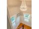 Elegant staircase featuring a stunning chandelier and natural light from multiple windows at 908 N Tremain St, Mount Dora, FL 32757