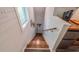 Wooden staircase leading downstairs, featuring white shiplap walls and a railing at 908 N Tremain St, Mount Dora, FL 32757