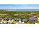 A neighborhood with lakeside views, lush greenery, and single-Gathering homes with well-manicured lawns at 1016 Pickering Path, The Villages, FL 32163