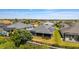 An elevated shot of a house with solar panels and a screened-in patio in a residential neighborhood at 1016 Pickering Path, The Villages, FL 32163