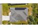 Bird's eye view of a home featuring solar panels and a screened-in patio on a well-manicured lot at 1016 Pickering Path, The Villages, FL 32163