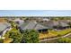 An aerial view showcases a home with a screened-in lanai and well-maintained backyard at 1016 Pickering Path, The Villages, FL 32163