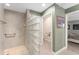Ensuite bathroom features a walk-in shower with glass block and access to the water closet at 1016 Pickering Path, The Villages, FL 32163