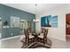 Dining room features a glass table with seating for four and sliding doors leading to an outside area at 1016 Pickering Path, The Villages, FL 32163