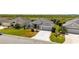 Charming one story home with a manicured lawn, long driveway and lush landscaping at 1016 Pickering Path, The Villages, FL 32163