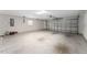 Spacious two-car garage with an automatic door, utility boxes, and room for storage at 1016 Pickering Path, The Villages, FL 32163