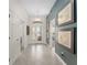Bright and spacious entry hallway featuring tiled floors and decorative artwork at 1016 Pickering Path, The Villages, FL 32163