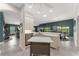 Open-concept kitchen with a center island and views of the living and dining areas at 1016 Pickering Path, The Villages, FL 32163