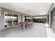 Large, covered lanai with tile flooring, ceiling fans, and views of backyard at 1016 Pickering Path, The Villages, FL 32163