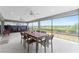 Covered lanai with ceiling fans, dining table, and seating for outdoor relaxation at 1016 Pickering Path, The Villages, FL 32163