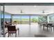 Screened lanai with ceiling fans and views of the open backyard space at 1016 Pickering Path, The Villages, FL 32163