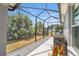 Screened-in lanai with grill for outdoor cooking with private backyard views at 1016 Pickering Path, The Villages, FL 32163