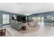 Inviting living room with high ceilings, a cozy seating arrangement, and seamless access to the outdoor area at 1016 Pickering Path, The Villages, FL 32163