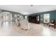 Bright and airy living room, showcasing a tile floor, a large rug, and neutral furniture at 1016 Pickering Path, The Villages, FL 32163