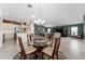 Open floor plan features a round glass dining table and views into the home's kitchen and living areas at 1016 Pickering Path, The Villages, FL 32163