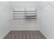 Organized walk-in closet with carpet and shelving for ample storage space at 1016 Pickering Path, The Villages, FL 32163