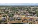 Aerial view of a neighborhood with houses and trees in a residential area at 1017 Bluegrass Dr, Groveland, FL 34736