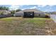 Spacious backyard featuring a screened lanai and grill, perfect for outdoor gatherings at 1017 Bluegrass Dr, Groveland, FL 34736