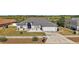 Landscaped single-Gathering home featuring a two-car garage and a well-manicured front lawn at 1017 Bluegrass Dr, Groveland, FL 34736