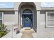 Elegant entryway featuring a blue front door with decorative wreath and side windows at 1017 Bluegrass Dr, Groveland, FL 34736