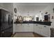 Open-concept kitchen with long counter extending into adjacent living area at 1017 Bluegrass Dr, Groveland, FL 34736