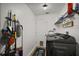 Laundry room featuring washer, shelving, and cleaning supplies on a wall mount at 1017 Bluegrass Dr, Groveland, FL 34736