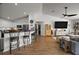 Living room offers open concept to kitchen with breakfast bar and stainless steel appliances at 1017 Bluegrass Dr, Groveland, FL 34736