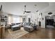 Spacious living room with sectional sofa, ceiling fan, wood floors, and neutral rug at 1017 Bluegrass Dr, Groveland, FL 34736