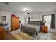 Comfortable bedroom featuring gray furniture, wood floors, and natural light at 1017 Bluegrass Dr, Groveland, FL 34736