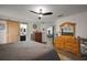 Well-lit bedroom with wood floors, barn door entrance to bathroom, and an array of furnishings at 1017 Bluegrass Dr, Groveland, FL 34736