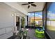 Screened patio with seating and view of fenced backyard at 1017 Bluegrass Dr, Groveland, FL 34736