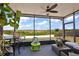 Screened patio with ceiling fan, table with chairs and views of the backyard at 1017 Bluegrass Dr, Groveland, FL 34736