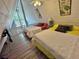 Charming bedroom with a-frame ceilings, featuring two comfortable beds and bright, natural lighting from unique windows at 10301 Us Highway 27 # 63, Clermont, FL 34711