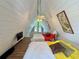 A-frame bedroom with vaulted ceiling, large windows, comfortable bedding, and a cozy retreat with a unique architectural design at 10301 Us Highway 27 # 63, Clermont, FL 34711