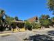 Exterior view of the well-maintained clubhouse with ample parking and lush landscaping at 10301 Us Highway 27 # 63, Clermont, FL 34711