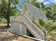 Exterior view of the back of the house, featuring stairs up to a second story deck at 10301 Us Highway 27 # 63, Clermont, FL 34711