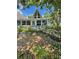 Charming home exterior featuring a unique A-frame window and inviting landscaping at 10301 Us Highway 27 # 63, Clermont, FL 34711