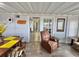 Inviting interior with dining area and a glimpse into the living space with cozy brown recliner at 10301 Us Highway 27 # 63, Clermont, FL 34711