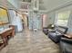 Charming living area featuring a spiral staircase, gray accent walls and stylish wood-look flooring at 10301 Us Highway 27 # 63, Clermont, FL 34711