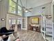 Cozy living room area featuring spiral stairs, high ceilings, a fan and wood-look floors at 10301 Us Highway 27 # 63, Clermont, FL 34711