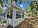 Bright sunroom with large windows offering plenty of natural light and views of the landscaped yard at 10301 Us Highway 27 # 63, Clermont, FL 34711
