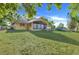 Lush backyard with a well-maintained lawn and a charming screened-in porch, perfect for outdoor enjoyment at 10640 Parkway Dr, Clermont, FL 34711