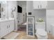 Bright bathroom features white cabinets and tile floors at 10640 Parkway Dr, Clermont, FL 34711