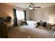 Carpeted bedroom featuring a comfortable bed, natural light and a ceiling fan at 10640 Parkway Dr, Clermont, FL 34711