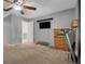 Neutral bedroom featuring a ceiling fan, television, and a dresser with a wood finish at 10640 Parkway Dr, Clermont, FL 34711