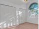 Bedroom with carpeted floors, large window, and closet with bi-fold doors at 10640 Parkway Dr, Clermont, FL 34711