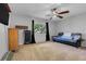 Spacious bedroom with carpet, a ceiling fan, and a window at 10640 Parkway Dr, Clermont, FL 34711